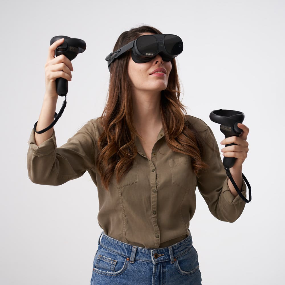 woman standing moving her arms, practicing physical therapy with virtual reality